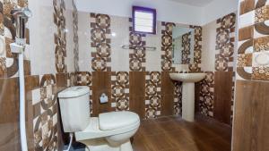 a bathroom with a toilet and a sink at Sigiri Binara Villa in Sigiriya