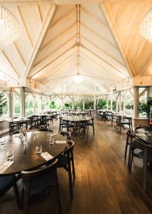 a dining room with tables and chairs in a tent at The Moat House in Stafford