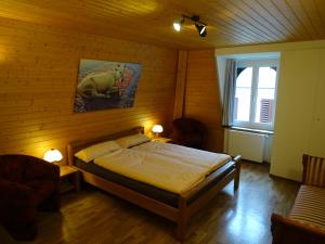 a bedroom with a bed in a wooden room at Bio Bed & Breakfast Froschkönig in Gersau