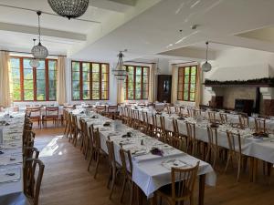 a large room with tables and chairs in it at Chalet Hotel d Ailefroide in Ailefroide