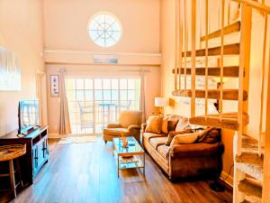 a living room with a couch and bunk beds at 2 Bd, Oceanfront Oasis, Lots of deals and Winter Texans book early in Galveston