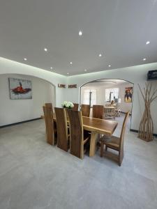 a dining room with a wooden table and chairs at Villa Mauritius in Albion