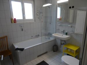 a bathroom with a tub and a sink at Bio Bed & Breakfast Froschkönig in Gersau +78 photos