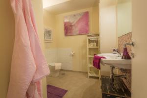 a bathroom with a sink and a toilet at Viterbo Antica Casa Vacanze in Viterbo