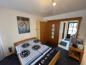 a bedroom with a bed with a black and white comforter at Smans Fewo in Neustadt in Holstein
