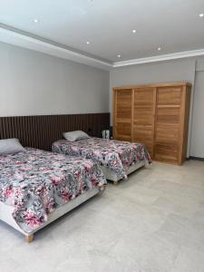 a bedroom with two beds and a wooden cabinet at Villa Mauritius in Albion +7 photos