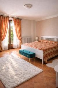 a bedroom with a large bed and a rug at LA CASA DI TALIN - Camere e appartamenti - Accoglienza adults only in Serravalle delle Langhe +43 photos