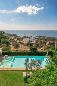 an outdoor swimming pool with a view of the ocean at Hotel Montecallini - Adult Only 14 in Leuca