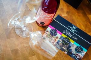 a bottle of wine and a glass on a table at Ferienwohnung CityVibes in Winterberg +26 photos
