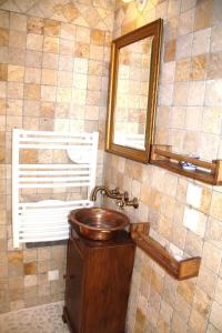 a bathroom with a wooden sink and a mirror at La Parenthèse ardéchoise - Spa et billard - Se ressourcer entre ville et forêt in Privas
