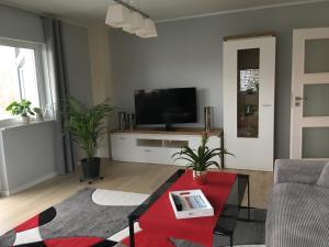 a living room with a flat screen tv on a table at Lakehouse in Brodowin in Chorin