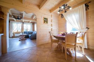 a dining room with a table and a couch at Smrekowy Dworek in Kościelisko
