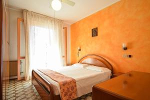 a bedroom with a bed and a large window at Jans e Gracy - Appartamenti e camere in Gabicce Mare