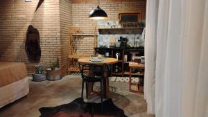 a room with a table and a brick wall at Doce inga in Cairu +7 photos