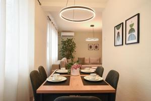a dining room with a table with chairs and a couch at M&S Central Residence in Bitola