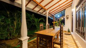 a wooden table on the porch of a house at Sigiri Binara Villa in Sigiriya