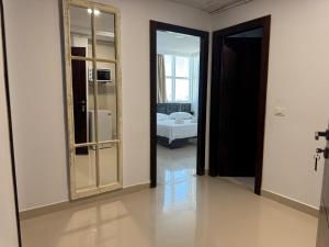 a room with a mirror and a room with a bed at Le Charbon Mystique in Sfax +2 photos