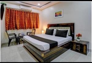 a bedroom with a large bed and a window at Hotel Om Sai And Lodging in Panvel