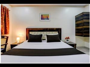 a bedroom with a large white bed in a room at Hotel Om Sai And Lodging in Panvel