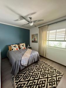 a bedroom with a bed and a ceiling fan at Paarl View House in Paarl +13 photos