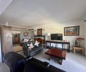 a living room with a couch and a table at Paarl View House in Paarl