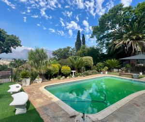 a swimming pool in the yard of a house at Paarl View House in Paarl