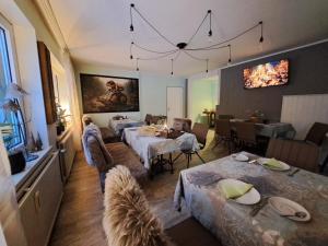 a living room with two tables and a dining room at Holl & Boll in Clausthal-Zellerfeld