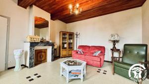 a living room with two chairs and a fireplace at Laguzou in Saint-Julien-de-Briola