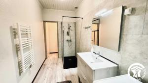 a white bathroom with a shower and a sink at Laguzou in Saint-Julien-de-Briola +22 photos