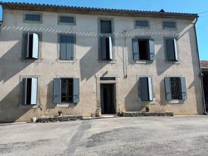 a large stone building with a lot of windows at Laguzou in Saint-Julien-de-Briola