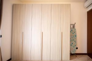 a large wooden cabinet in a room at Casa Alexandra in Pantigliate