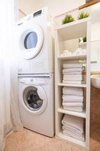 a laundry room with a washer and dryer at Casa Alexandra in Pantigliate