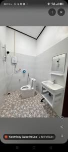 a bathroom with a toilet and a sink at Keomisay in Nongkhiaw