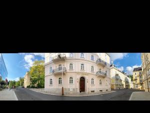 a large white building on the side of a street at Gold Residence in Mariánské Lázně
