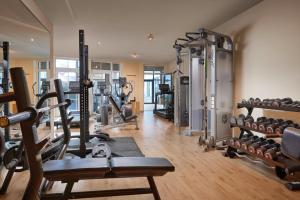 a gym with several treadmills and lots of machines at Alpin Chalets Oberjoch in Bad Hindelang