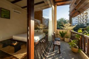 a balcony with a bedroom and a bed on a balcony at ZenHome by M2 in Hoi An