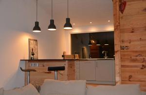 a living room with a counter and a kitchen at Boutique Alpine Chalet with Panoramic Views in Thollon
