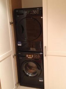 a washer and dryer in a room with a door at Boutique Alpine Chalet with Panoramic Views in Thollon