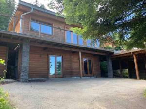 a house with a large driveway in front of it at Boutique Alpine Chalet with Panoramic Views in Thollon