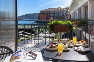 a table with food on a balcony with a view at Grand Hotel Dino in Baveno