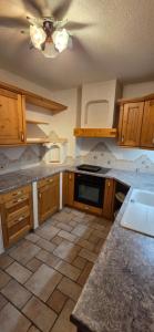 a kitchen with wooden cabinets and a ceiling at Ferienwohnung Baumgartner in Aigen im Ennstal