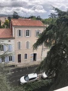 two cars parked in a parking lot in front of a building at La Tour Jayan in Agen