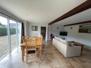 a living room with a table and a couch at Cumberwell Cottages-Dash Corner in South Wraxall