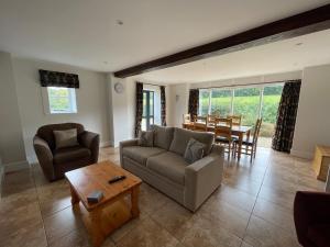 a living room with a couch and a table at Cumberwell Cottages-Dash Corner in South Wraxall