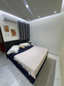 a bedroom with a large bed in a room at JB condominio b in Maceió