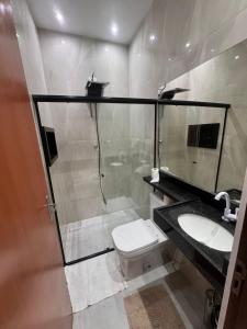 a bathroom with a shower and a toilet and a sink at JB condominio b in Maceió