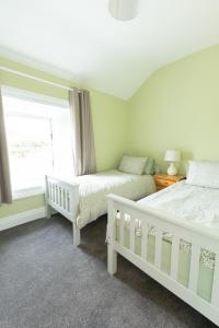 a bedroom with two beds and a window at Making Tracks Hostel in Portlaoise