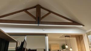 a light hanging from a ceiling in a room at Guest house arboré in Saint-Loubès