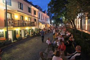 a group of people sitting on a street at night at Blue Horizon Apartment in Balatonfüred +8 photos