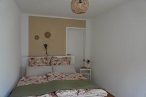 a bedroom with a bed with a comforter on it at Moor and More Loft in Monschau